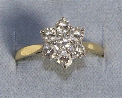 Lot 671 - An 18 Carat Gold Diamond Cluster Ring, seven round brilliant cut diamonds in claw settings, to...