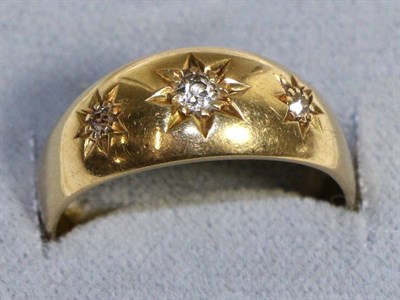 Lot 673 - An 18 Carat Gold Diamond Ring, star set with three graduated old cut diamonds to a tapering...