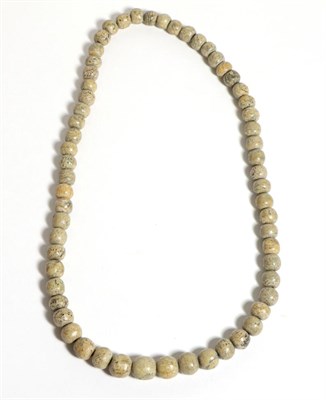 Lot 674 - A Mammoth Bone Bead Necklace, as a continuous strand of slightly graduated round beads, length 60cm