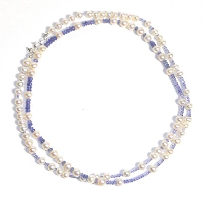 Lot 676 - A Tanzanite and Cultured Pearl Necklace, graduated smooth tanzanite beads spaced at intervals...