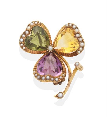 Lot 681 - A Victorian, Gem and Seed Pearl Clover Brooch, a heart cut amethyst, citrine and green paste within