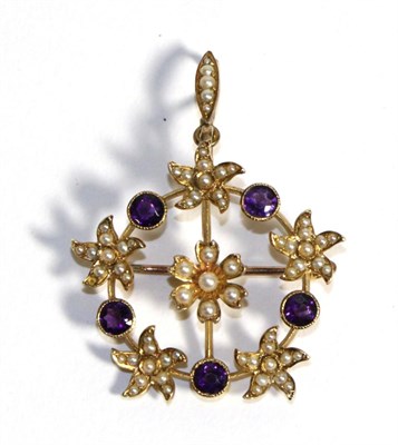 Lot 683 - An Amethyst and Seed Pearl Brooch/Pendant, a central floral cluster of seed pearls within a...