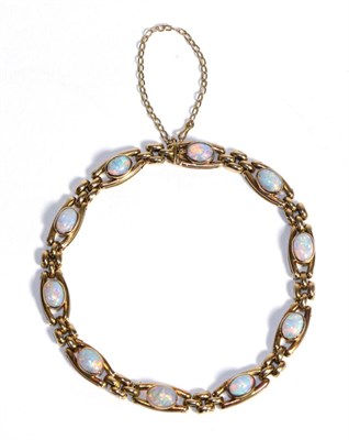 Lot 684 - An Opal Bracelet, oval cabochon opals in rubbed over settings to two bar links, spaced by groups of