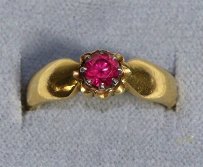 Lot 691 - A 22 Carat Gold Ruby Ring, a round cut ruby in a claw setting with a collet border, to pinched...