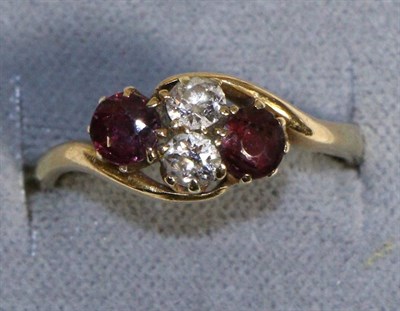 Lot 701 - A Garnet and Diamond Ring, two old cut diamonds flanked each side by a round cut garnet, to...