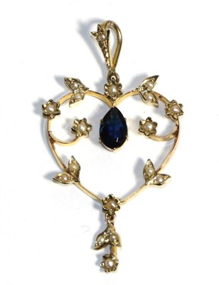 Lot 709 - An Edwardian Sapphire and Seed Pearl Pendant, a pear cut sapphire in a claw setting to a heart...