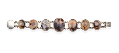 Lot 714 - A Dendritic Agate Bracelet, seven graduated oval cabochon agate in rubbed over settings, to an oval