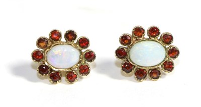 Lot 716 - A Pair of Opal and Hessonite Garnet Cluster Earrings, an oval cabochon opal in a collet...