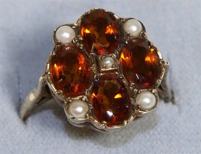 Lot 721 - A 9 Carat Gold Citrine and Seed Pearl Ring, four oval cut citrine spaced by seed pearls in...