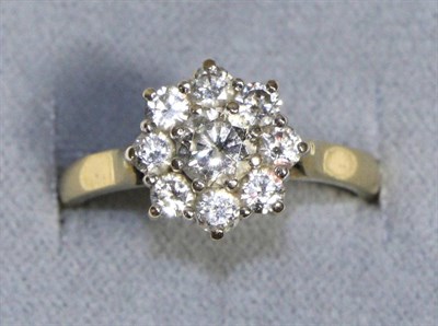 Lot 725 - An 18 Carat Gold Diamond Cluster Ring, a round brilliant cut diamond within a border of smaller...