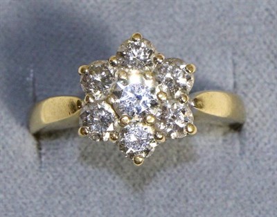 Lot 726 - An 18 Carat Gold Diamond Cluster Ring, round brilliant cut diamonds in claw settings, to knife edge