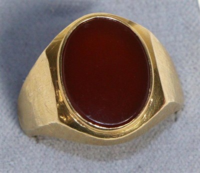 Lot 728 - A Carnelian Signet Ring, an oval cut carnelian in a rubbed over setting, to tapering brushed...