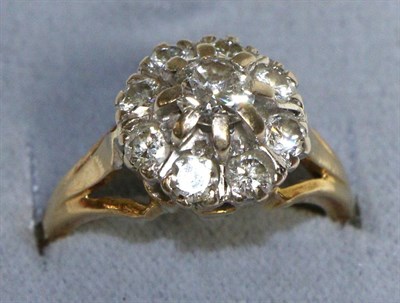 Lot 729 - A Diamond Cluster Ring, a round brilliant cut diamond within a border of smaller round...