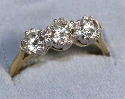 Lot 732 - An 18 Carat Gold Diamond Three Stone Ring, graduated round brilliant cut diamonds in claw settings