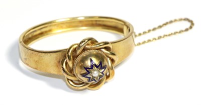 Lot 734 - A Victorian Pearl and Enamel Bangle, a central dome with a star set pearl within a blue enamel...