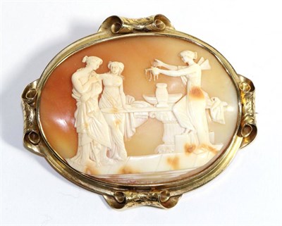 Lot 735 - A Carved Shell Cameo Brooch, depicting the Toilet of Venus in a scroll frame, measures 7cm by 8cm