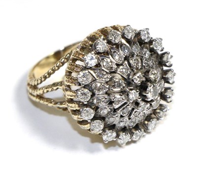 Lot 740 - A Diamond Cluster Ring, a high dome set throughout with round brilliant cut diamonds, to forked...