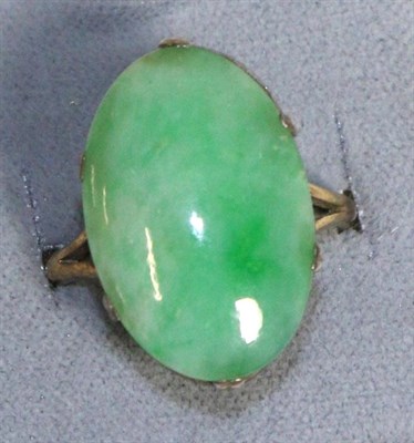 Lot 767 - A Jade Ring, an oval cabochon jade in a claw setting, to forked shoulders, finger size M1/2