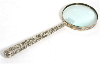 Lot 805 - A White Metal Mounted Magnifying Glass, circa 1900, the handle, probably Indian, chased with...