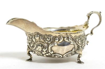 Lot 821 - A George II Silver Sauceboat, maker's mark rubbed, London 1740, with shaped rim and leaf capped...