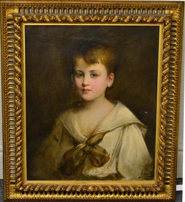 Lot 908 - C E Hall (early 20th century)   Portrait of a young boy wearing a loose white shirt tied with a bow