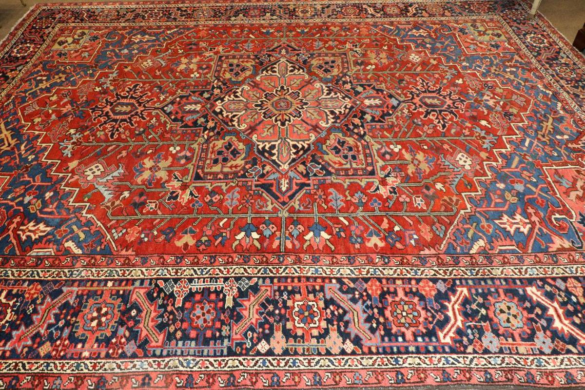 Lot 1101 - Heriz Carpet of unusual size Iranian Azerbaijan, circa 1910 The blood red field of angular...