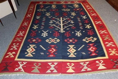 Lot 1118 - Thrace Kilim European Turkey, circa 1930 The shaded indigo field of stylised birds on and...