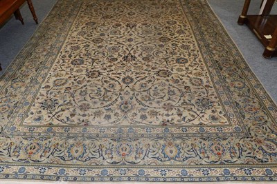 Lot 1123 - Kashan Carpet West Iran, circa 1950 The ivory field of scrolling vines and palmettes enclosed...