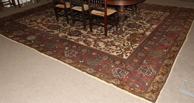 Lot 1124 - Indian Carpet, circa 1920 The pale camel field with an allover design of large flowerheads,...