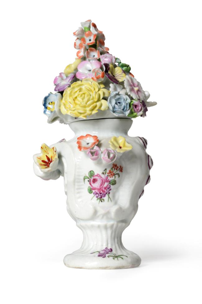 Lot 24 - A Longton Hall Vase and Cover, circa 1755, of rococo scroll moulded form applied with...