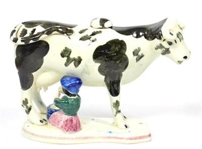 Lot 69 - A Pearlware Cow Creamer and Stopper, early 19th century, the standing beast with black...