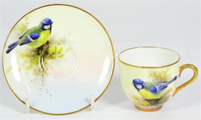 Lot 102 - A Royal Worcester Porcelain Cabinet Cup and Saucer, by Ernest Barker, 1937, painted with Blue...