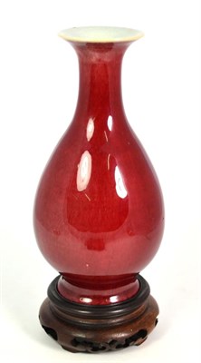 Lot 179 - A Chinese Sang de Boeuf Glazed Porcelain Bottle Vase, 19th century, with everted rim, 23.5cm high