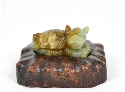 Lot 217 - A Chinese Jade Lion Dog, in Ming style, naturalistically modelled recumbent, 5.5cm wide, on...