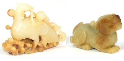 Lot 231 - A Carved Jade Figure of a Phoenix, holding a fruiting branch, 8.5cm; and A Similar Lion Dog,...