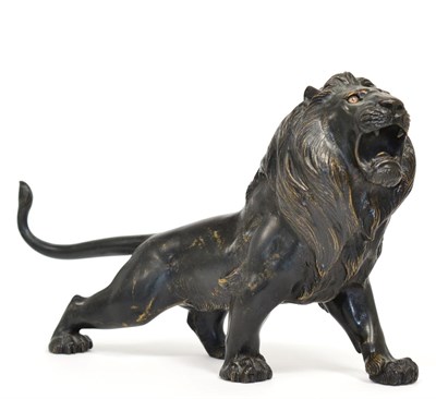 Lot 246 - A Japanese Bronze Figure of a Lion, Meiji period, prowling, its head raised to roar, 34cm long