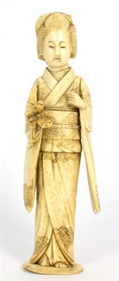 Lot 249 - A Japanese Ivory Okimono, Meiji period, as a geisha holding a butterfly, 8cm high