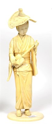 Lot 259 - A Japanese Ivory Okimono, Meiji period, as a girl in traditional dress playing a shamisen, on...