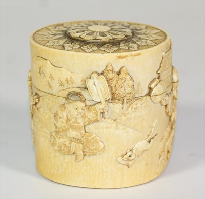 Lot 262 - A Japanese Ivory Box and Cover, Meiji period, carved with figured and animals in landscape, 9cm...