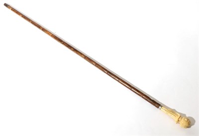 Lot 264 - A Japanese Ivory Mounted Walking Cane, Meiji period, the handle carved as a stylised figure,...