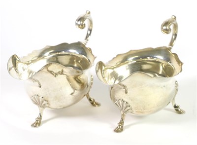 Lot 300 - A Pair of George III Style Silver Sauceboats, Walker & Hall, Sheffield 1920, with flying scroll...