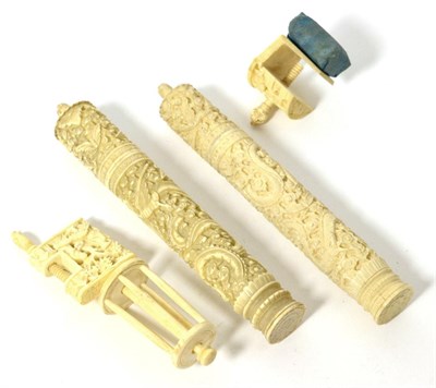 Lot 363 - Two Similar 19th Century Chinese Cylindrical Ivory Bodkin Cases, carved overall with dragons...