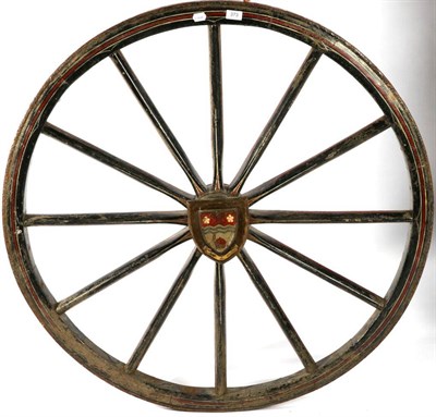 Lot 373 - An Iron Shod Painted Wood Carriage Wheel, 144cm diameter, later applied with a shield depicting the