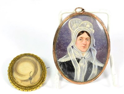 Lot 396 - A Mourning Brooch, of glazed locket form containing hairwork, enclosed by an engraved yellow...