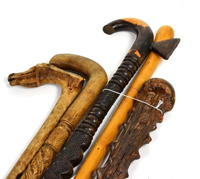 Lot 422 - A Group of Five Walking Sticks and Canes, one with the handle carved as a horse's head