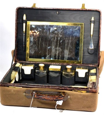 Lot 443 - A Crocodile Skin Vanity Case, early 20th century, fitted and containing gilt metal mounted bottles