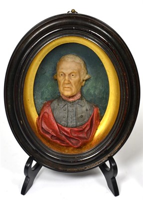 Lot 446 - A Wax Portrait Bust of a Gentleman, circa 1770, wearing blue jacket and red cloak, in a glazed oval