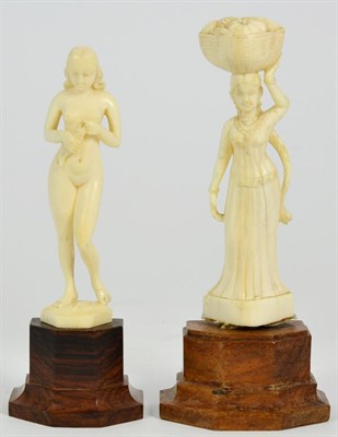 Lot 455 - An Indo-Portuguese Ivory Figure of a Nude, 19th century, standing holding a fish on a base,...