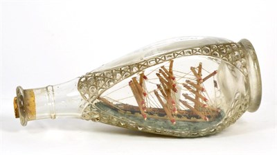 Lot 478 - A Model Ship in a Glass Bottle, late 19th/early 20th century, the three-masted boat in a...