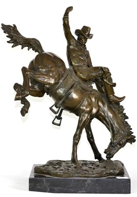 Lot 492 - A Bronze Figure of a Cowboy Riding a Bucking Broncho, on a black slate base, 48cm high